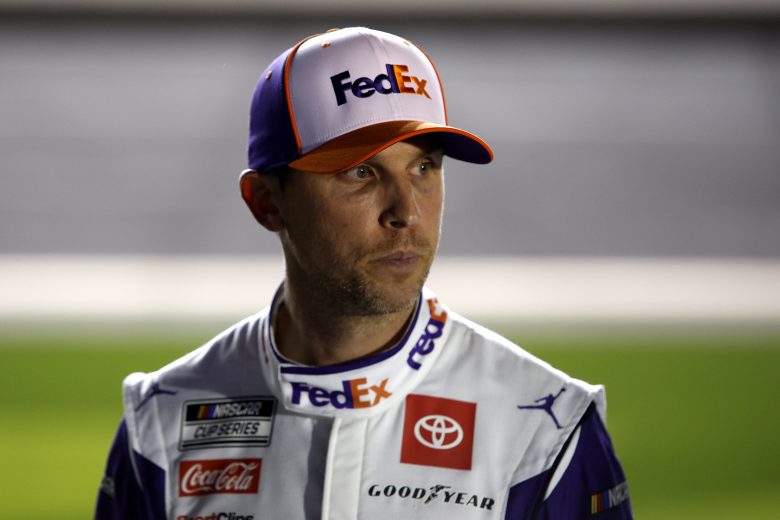 DAYTONA BEACH, FLORIDA - FEBRUARY 16: Denny Hamlin, driver of the #11 FedEx Express Toyota, stands on the grid during qualifying for the NASCAR Cup Series 64th Annual Daytona 500 at Daytona International Speedway on February 16, 2022 in Daytona Beach, Florida. (Photo by Sean Gardner/Getty Images) | Getty Images