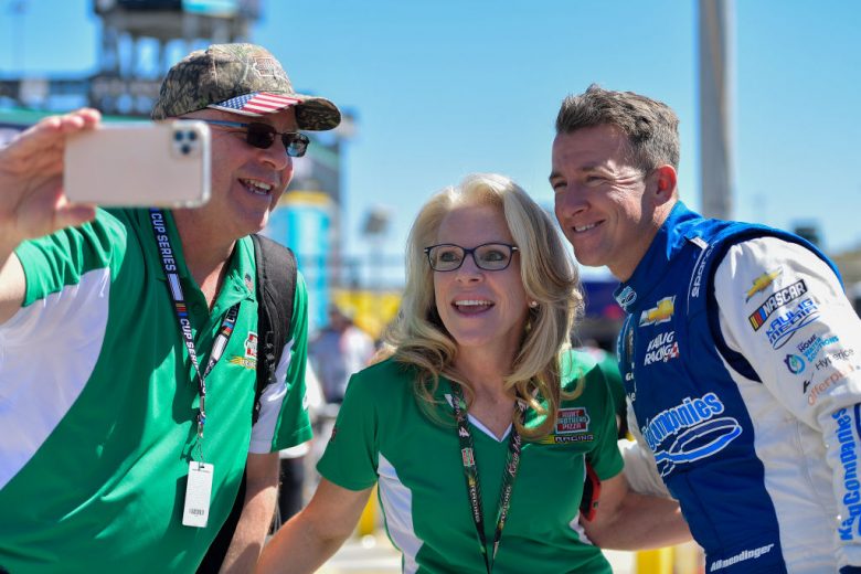 AVONDALE, ARIZONA - MARCH 12: AJ Allmendinger, driver of the #16 Action Industries Chevrolet, and guest pose foe a selfie on the grid during qualifying for the Ruoff Mortgage 500 at Phoenix Raceway on March 12, 2022 in Avondale, Arizona. (Photo by Logan Riely/Getty Images) | Getty Images