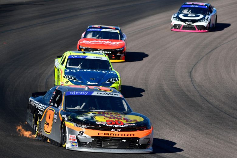 AVONDALE, ARIZONA - MARCH 12: Noah Gragson, driver of the #9 Bass Pro Shops/TrueTimber/BRCC Chevrolet, leads Brandon Jones, driver of the #19 Menards/Jeld-Wen Toyota, Justin Allgaier, driver of the #7 BRANDT Chevrolet, and Trevor Bayne, driver of the #18 Devotion Nutrition Toyota, during the NASCAR Xfinity Series United Rentals 200 at Phoenix Raceway on March 12, 2022 in Avondale, Arizona. (Photo by Logan Riely/Getty Images) | Getty Images