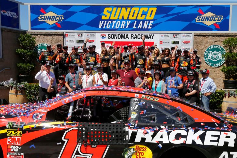 SONOMA, CALIFORNIA - JUNE 23: Martin Truex Jr., driver of the #19 Bass Pro Shops Toyota, and his team celebrate in Victory Lane after winning the Monster Energy NASCAR Cup Series Toyota/Save Mart 350 at Sonoma Raceway on June 23, 2019 in Sonoma, California. (Photo by Jonathan Ferrey/Getty Images) | Getty Images