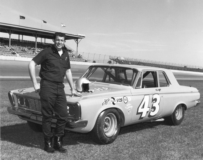 DAYTONA BEACH, FL - 1963:  Richard Petty poses with his Plymouth NASCAR Cup car at Daytona International Speedway. Petty finished sixth in the Daytona 500 and was eighth in the Firecracker 400. (Photo by ISC Images & Archives via Getty Images)