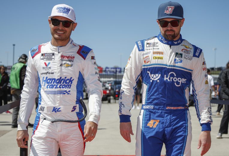 HAMPTON, GEORGIA - MARCH 20: Kyle Larson, driver of the #5 HendrickCars.com Chevrolet, (L) and Ricky Stenhouse Jr., driver of the #47 Kroger/SweetLeaf Chevrolet, walk the red carpet prior to the NASCAR Cup Series Folds of Honor QuikTrip 500 at Atlanta Motor Speedway on March 20, 2022 in Hampton, Georgia. (Photo by Sean Gardner/Getty Images) | Getty Images