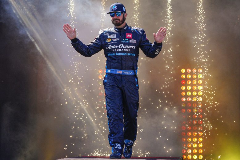 RICHMOND, VIRGINIA - APRIL 03: Martin Truex Jr., driver of the #19 Auto-Owners Insurance Toyota, waves to fans onstage during driver intros prior to the NASCAR Cup Series Toyota Owners 400 at Richmond Raceway on April 03, 2022 in Richmond, Virginia. (Photo by Jacob Kupferman/Getty Images) | Getty Images