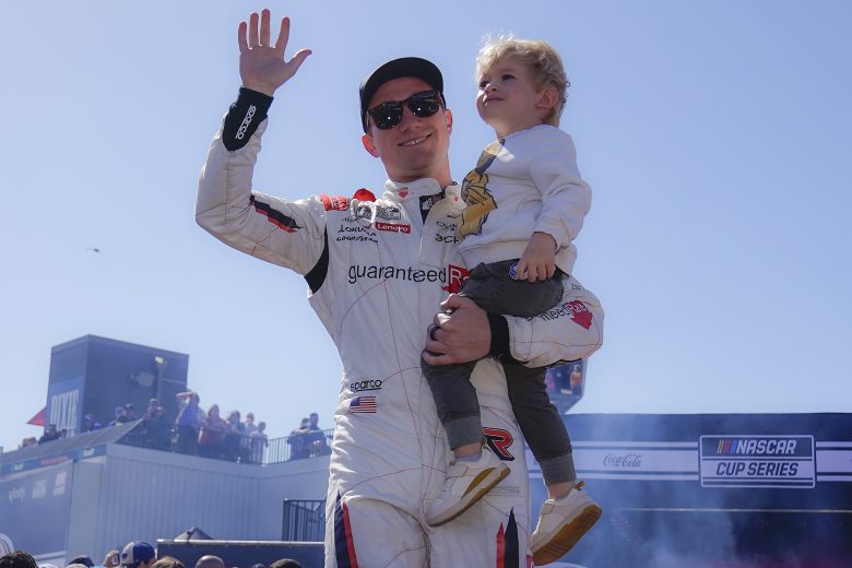 RICHMOND, VIRGINIA - APRIL 03: Tyler Reddick, driver of the #8 Guaranteed Rate Chevrolet, waves to fans holding his son, Beau onstage during driver intros prior to the NASCAR Cup Series Toyota Owners 400 at Richmond Raceway on April 03, 2022 in Richmond, Virginia. (Photo by Jacob Kupferman/Getty Images) | Getty Images