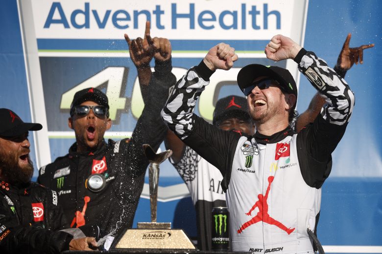 KANSAS CITY, KANSAS - MAY 15: Kurt Busch, driver of the #45 Jordan Brand Toyota, and crew celebrate in victory lane after winning the NASCAR Cup Series AdventHealth 400 at Kansas Speedway on May 15, 2022 in Kansas City, Kansas. (Photo by Chris Graythen/Getty Images) | Getty Images