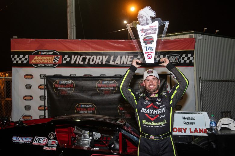 Doug Coby, driver of the #7 John Blewitt Inc, hoists his trophy in Victory Lane during the Miller Lite 200 for the Whelen Modified Tour at Riverhead Raceway on May 14, 2022 in Riverhead, New York. (Mike Lawrence/NASCAR)