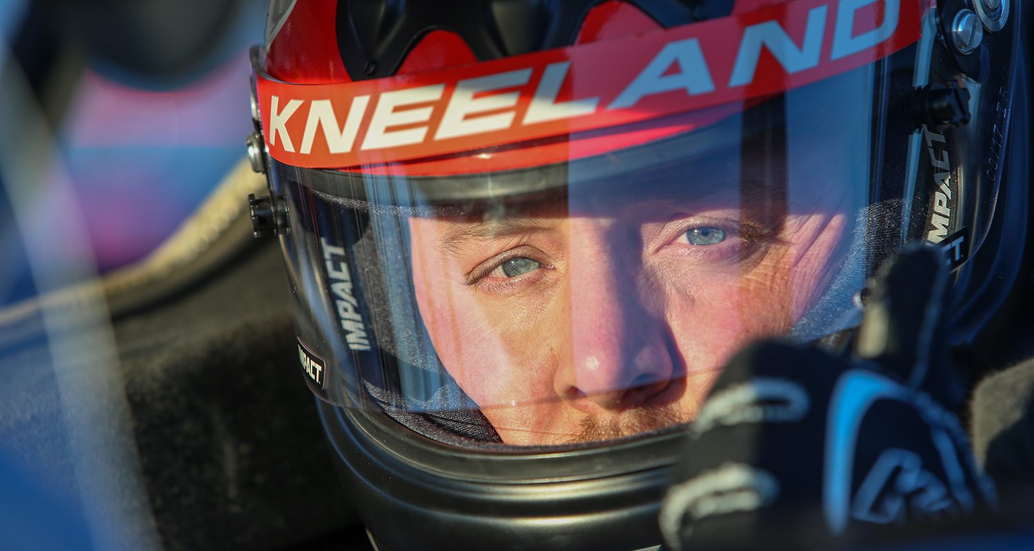 Derek Kneeland sits in his race car ahead of an event at North Carolina's Hickory Motor Speedway in 2021. (Photo: Adam Fenwick/NASCAR)