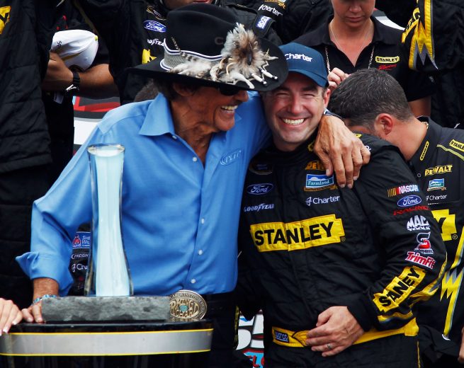 WATKINS GLEN, NY - AUGUST 12:  Marcos Ambrose, driver of the #9 Stanley Ford, celebrates with team owner Richard Petty in Victory Lane after winning the NASCAR Sprint Cup Series Finger Lakes 355 at the Glen at Watkins Glen International on August 12, 2012 in Watkins Glen, New York.  (Photo by Jeff Zelevansky/Getty Images) | Getty Images