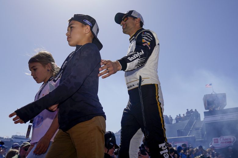 RICHMOND, VIRGINIA - APRIL 03: Aric Almirola, driver of the #10 Smithfield Ford, walks onstage with his daughter, Abby, and son, Alex during driver intros prior to the NASCAR Cup Series Toyota Owners 400 at Richmond Raceway on April 03, 2022 in Richmond, Virginia. (Photo by Jacob Kupferman/Getty Images) | Getty Images