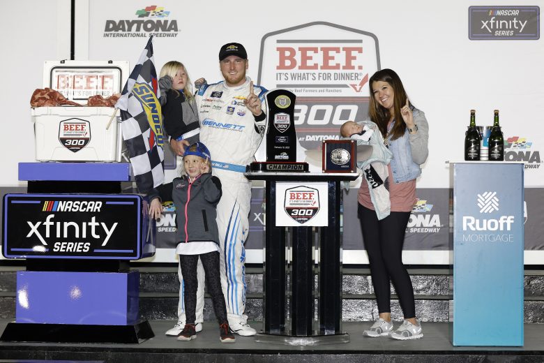 DAYTONA BEACH, FLORIDA - FEBRUARY 19: Austin Hill, driver of the #21 Bennett/United Rentals Chevrolet, celebrates with his wife Ashlyn, son Barrett Edward and daughters Lynnlee and Kenslee in the Ruoff Mortgage victory lane after winning the NASCAR Xfinity Series Beef. It's What's For Dinner. 300 at Daytona International Speedway on February 19, 2022 in Daytona Beach, Florida. (Photo by Chris Graythen/Getty Images) | Getty Images