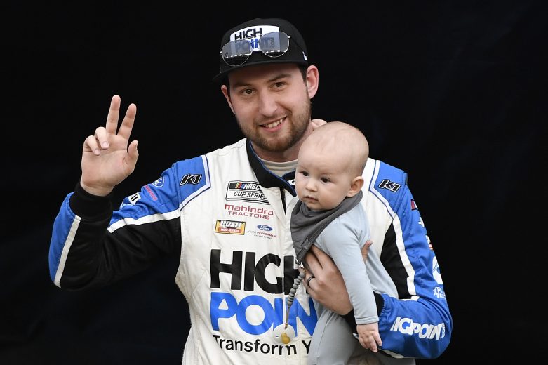 BRISTOL, TENNESSEE - APRIL 17: Chase Briscoe, driver of the #14 HighPoint.com Ford, waves to fans holding his son Brooks Wayne Cunningham during driver intros prior to the NASCAR Cup Series Food City Dirt Race at Bristol Motor Speedway on April 17, 2022 in Bristol, Tennessee. (Photo by Logan Riely/Getty Images) | Getty Images