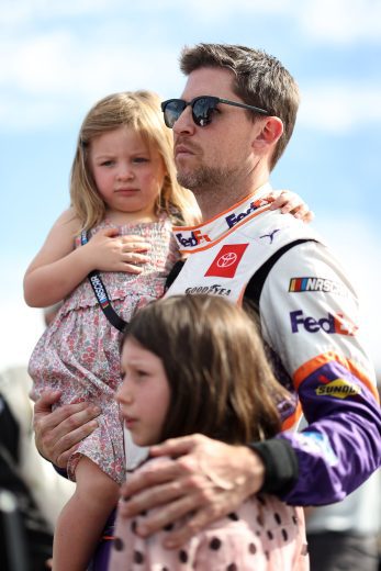 AVONDALE, ARIZONA - NOVEMBER 07: Denny Hamlin, driver of the #11 FedEx Express Toyota, spends time with his daughters Taylor and Molly, (top) on the grid prior to the NASCAR Cup Series Championship at Phoenix Raceway on November 07, 2021 in Avondale, Arizona. (Photo by Chris Graythen/Getty Images) | Getty Images