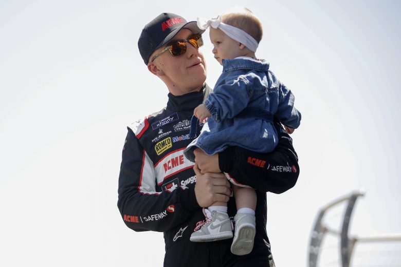 DOVER, DELAWARE - APRIL 30: John Hunter Nemechek, driver of the #18 AMCE Toyota, walks onstage holding his daughter daughter Aspen Palmer during driver intros prior to the NASCAR Xfinity Series A-GAME 200 at Dover Motor Speedway on April 30, 2022 in Dover, Delaware. (Photo by Sean Gardner/Getty Images) | Getty Images