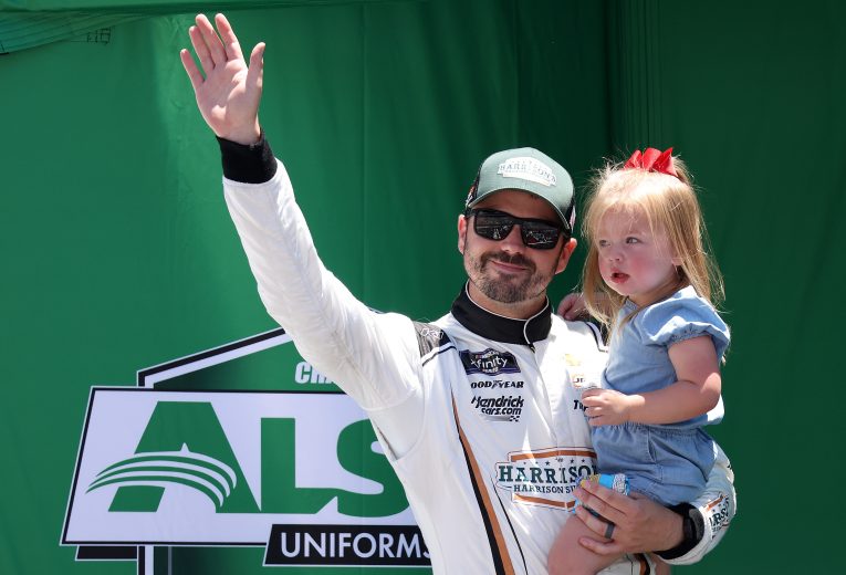 CONCORD, NORTH CAROLINA - MAY 28: Josh Berry, driver of the #8 Harrison's USA Chevrolet, waves to fans holding his daughter Mackenzie onstage during driver intros prior to the NASCAR Xfinity Series Alsco Uniforms 300 at Charlotte Motor Speedway on May 28, 2022 in Concord, North Carolina. (Photo by James Gilbert/Getty Images) | Getty Images