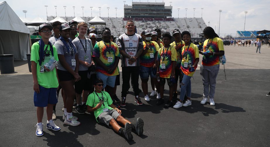 Kane Brown poses with members of the Boys & Girls Club in the infield of the Nashville Superspeedway