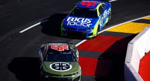 Ty Dillon and Erik Jones race on the track.