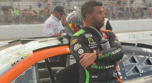 Bubba Wallace by his No. 23 car post-race at New Hampshire Motor Speedway