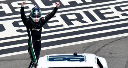 Chandler Smith lifts his arms to celebrate Pocono win