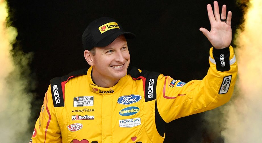 Michael McDowell waves to crowd in Love's fire suit