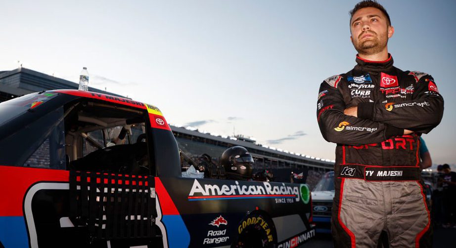 Ty Majeski stands outside his truck with arms crossed