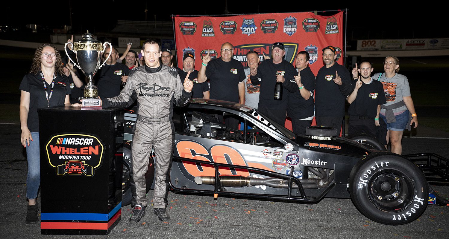 Matt Hirschman, driver of #60 PeeDee Motorsports Modified car, poses for a photo with the pit crew after winning the inaugural Whelen Granite State Short Track Cup championship, during the Clash at Claremont 150 for the Whelen Modified Tour at Claremont Motorsports Park on July 29, 2022 in Claremont, New Hampshire. (Rachel O'Driscoll/NASCAR)