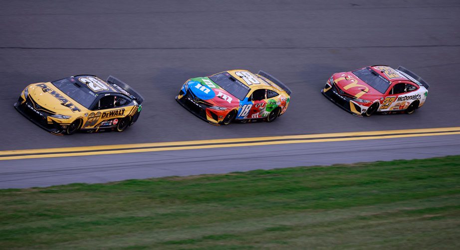 Christopher Bell, Kyle Busch and Bubba Wallace race.