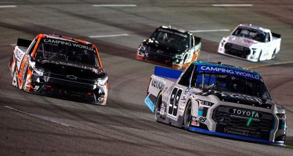 Ben Rhodes (99) leads a group of trucks at Richmond Raceway.