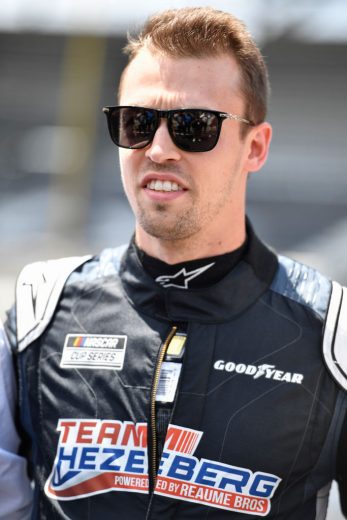 INDIANAPOLIS, INDIANA - JULY 31: Daniil Kvyat, driver of the #26 Hezeberg Systems Toyota, waits on the grid prior to the NASCAR Cup Series Verizon 200 at the Brickyard at Indianapolis Motor Speedway on July 31, 2022 in Indianapolis, Indiana. (Photo by Logan Riely/Getty Images) | Getty Images