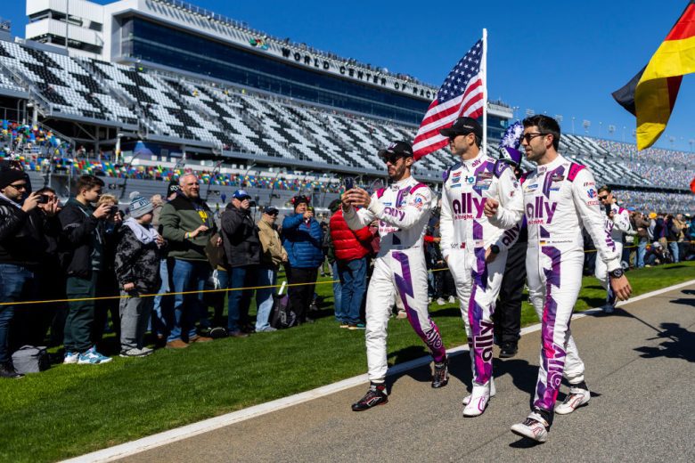 DAYTONA BEACH, FLORIDA - JANUARY 29: Jose Maria Lopez, Jimmie Johnson and Mike Rockenfeller, drivers of the #48 Ally Cadillac Racing Cadillac DPi, walk-on pit lane during prerace before the start of the Rolex 24 at Daytona International Speedway on January 29, 2022 in Daytona Beach, Florida. (Photo by James Gilbert/Getty Images) | Getty Images
