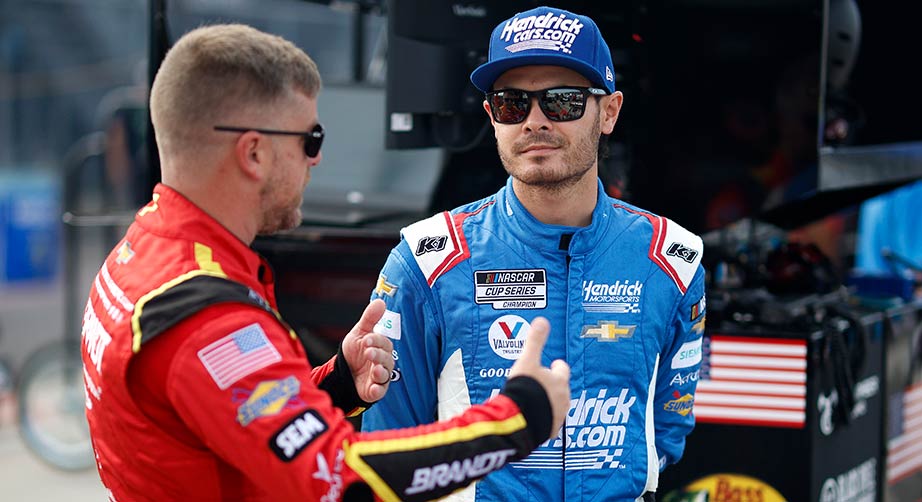 Kyle Larson, right, and Justin Allgaier talk it over during a break in the garage at Watkins Glen International