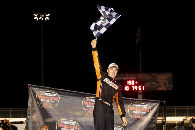 Craig Lutz, driver of the #82 Horton Avenue Materials, celebrates in victory lane after winning the Phoenix Communications 150 for the Whelen Modified Tour at Thompson Speedway Motorsports Park on August 18, 2022 in Claremont, New Hampshire. (Adam Glanzman/NASCAR)