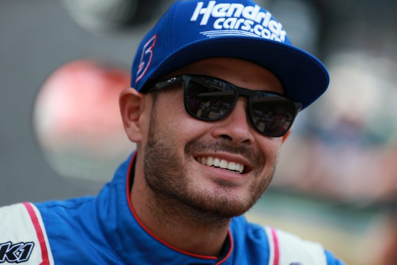 Kyle Larson smiles as he waits on the grid at Indianapolis.
