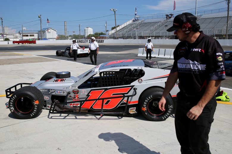 The crew works on the car of Ron Silk, driver of the #16 Blue Mountain Machine Modified in practice during the CheckeredFlag.com 150 for the NASCAR Whelen Modified Tour at Larry King Law's Langley Speedway on August 27, 2022 in Hampton, Virginia. (Ryan M. Kelly/NASCAR)