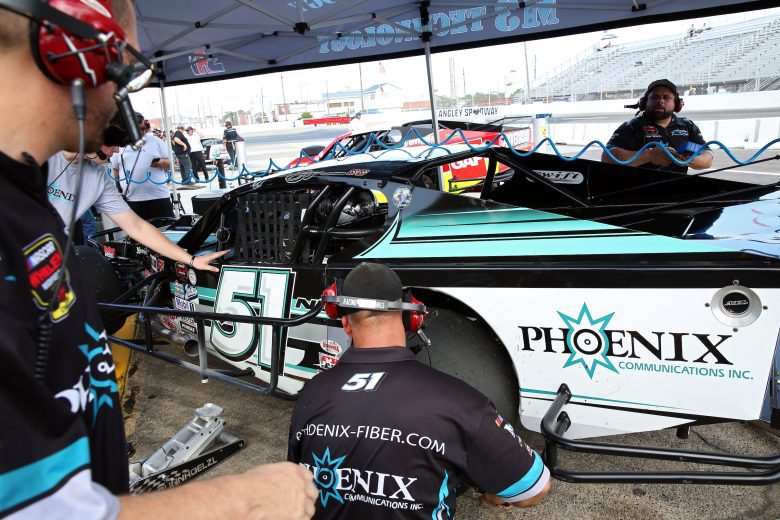 The crew works on the car of Justin Bonsignore, driver of the #51 Phoenix Communications, Inc. Modified in practice during the CheckeredFlag.com 150 for the NASCAR Whelen Modified Tour at Larry King Law's Langley Speedway on August 27, 2022 in Hampton, Virginia. (Ryan M. Kelly/NASCAR)