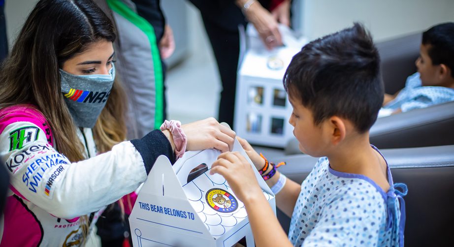 Child receives a bear at The NASCAR Foundation's Speedy Bear Brigade event in Mexico
