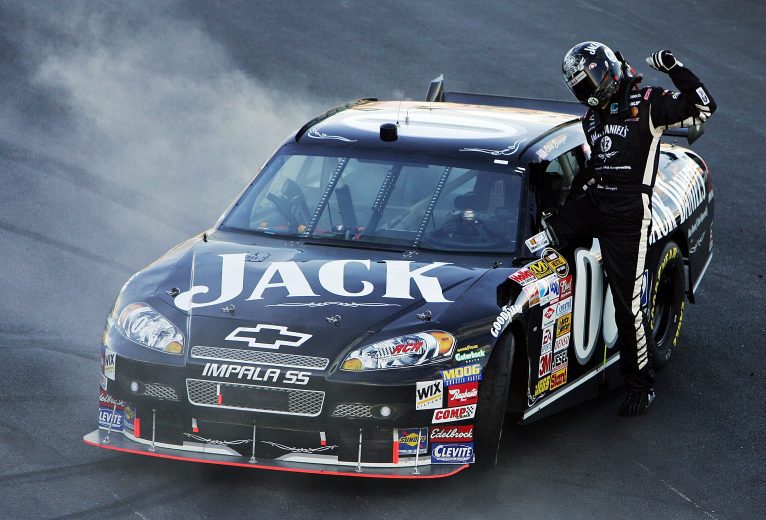 LOUDON, NH - SEPTEMBER 16: Clint Bowyer, driver of the #07 Jack Daniel's Chevrolet, climbs from his car after winning the NASCAR Nextel Cup Series Sylvania 300 at New Hampshire International Speedway on September 16, 2007 in Loudon, New Hampshire. (Photo by Al Bello/Getty Images) | Getty Images