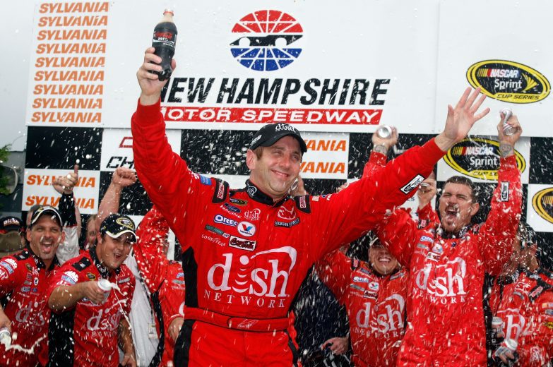 LOUDON, NH - SEPTEMBER 14: Greg Biffle, driver of the #16 Dish Network Turbo HD Ford, celebrates in victory lane after winning the NASCAR Sprint Cup Series Sylvania 300 at New Hampshire Motor Speedway on September 14, 2008 in Loudon, New Hampshire. (Photo by Jason Smith/Getty Images for NASCAR) | Getty Images