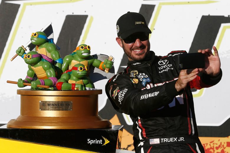 JOLIET, IL - SEPTEMBER 18: Martin Truex Jr, driver of the #78 Furniture Row/Denver Mattress Toyota, poses with the trophy in Victory Lane after winning the NASCAR Sprint Cup Series Teenage Mutant Ninja Turtles 400 at Chicagoland Speedway on September 18, 2016 in Joliet, Illinois. (Photo by Jeff Zelevansky/NASCAR via Getty Images)