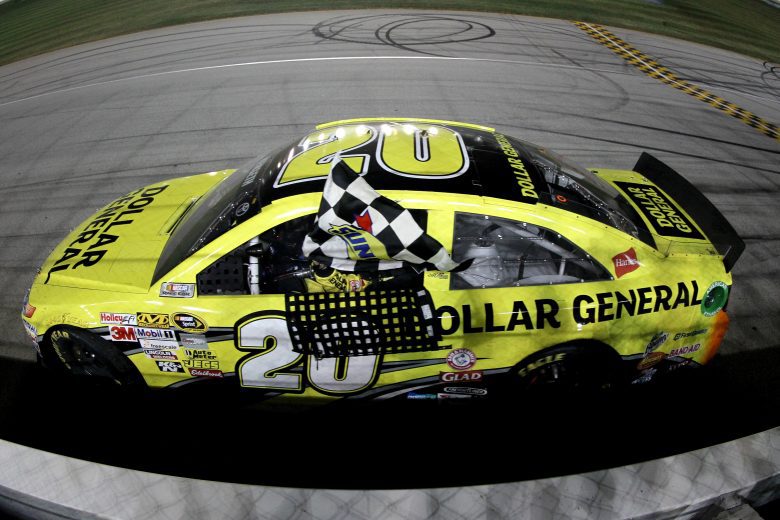 JOLIET, IL - SEPTEMBER 15: Matt Kenseth, driver of the #20 Dollar General Toyota, celebrates with the checkered flag after winning the NASCAR Sprint Cup Series Geico 400 at Chicagoland Speedway on September 15, 2013 in Joliet, Illinois. (Photo by Todd Warshaw/Getty Images) | Getty Images