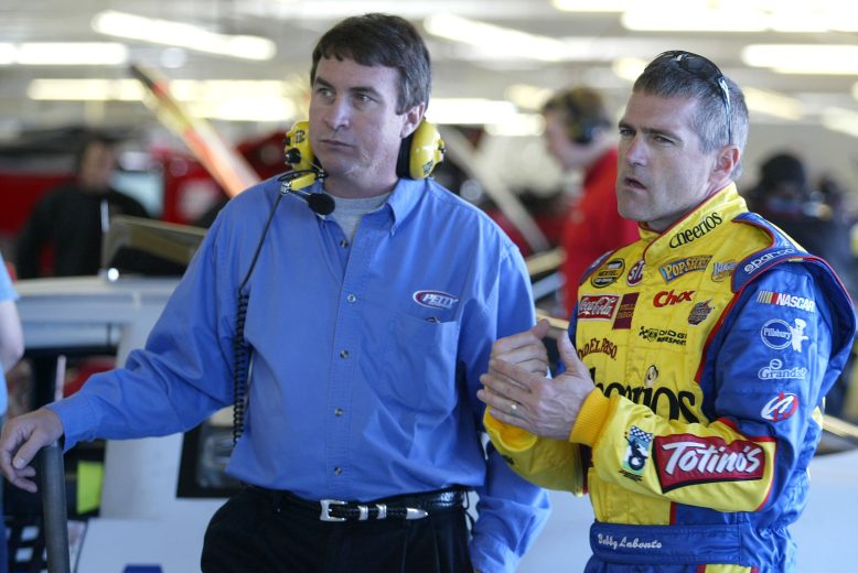 LAS VEGAS - JANUARY 31: Robby Loomis (L) of Petty Enterprises speaks with driver Bobby Labonte (R) of the #43 Cheerios Dodge, during the NASCAR Nextel Cup Series January Testing on January 31, 2006 at the Las Vegas Motor Speedway in Las Vegas, Nevada. (Photo by Todd Warshaw/Getty Images) | Getty Images