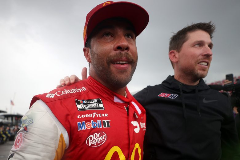 TALLADEGA, ALABAMA - OCTOBER 04: Bubba Wallace, driver of the #23 McDonald's Toyota, is congratulated on the grid by Denny Hamlin, driver of the #11 FedEx Express Toyota, (R) after winning the rain-shortened NASCAR Cup Series YellaWood 500 at Talladega Superspeedway on October 04, 2021 in Talladega, Alabama. (Photo by Chris Graythen/Getty Images) | Getty Images