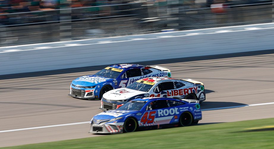 Bubba Wallace races to the inside in a three-wide battle at Kansas Speedway