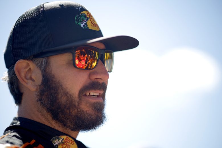 KANSAS CITY, KANSAS - SEPTEMBER 11: Martin Truex Jr., driver of the #19 Bass Pro Shops Red White Blue Toyota, waits on the grid prior to the NASCAR Cup Series Hollywood Casino 400 at Kansas Speedway on September 11, 2022 in Kansas City, Kansas. (Photo by Chris Graythen/Getty Images) | Getty Images