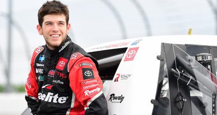 Chandler Smith looks on as he leads against his truck on the grid at Darlington Raceway