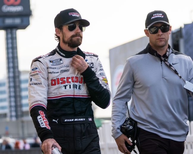 Ryan Blaney walks down pit road after advancing in the Cup Series Playoffs at the Charlotte Motor Speedway road course