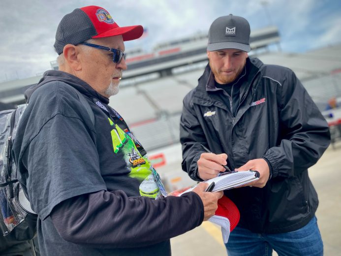 Austin Hill signs an autograph for a fan at Martinsville