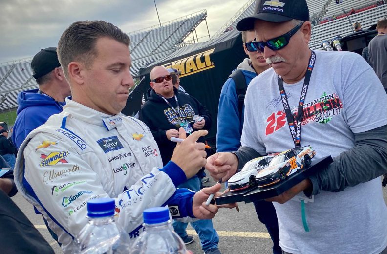AJ Allmendinger signs for a fan at Martinsville