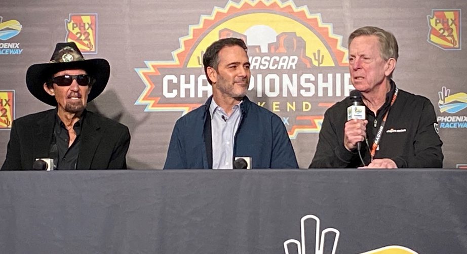 Jimmie Johnson sits between Richard Petty and Maury Gallagher