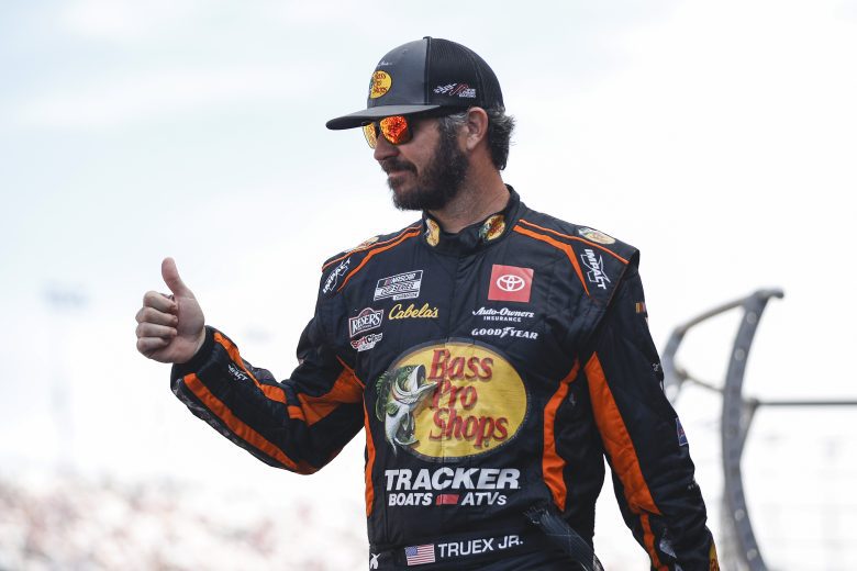 LAS VEGAS, NEVADA - OCTOBER 16: Martin Truex Jr, driver of the #19 Bass Pro Shops Toyota, gives a thumbs up to fans as he walks onstage during driver intros prior to the NASCAR Cup Series South Point 400 at Las Vegas Motor Speedway on October 16, 2022 in Las Vegas, Nevada. (Photo by Sean Gardner/Getty Images) | Getty Images