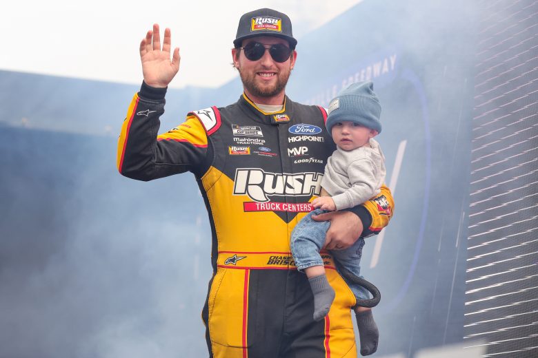 MARTINSVILLE, VIRGINIA - OCTOBER 30: Chase Briscoe, driver of the #14 Rush Truck Centers/Cummins Ford, waves to fans holding his son Brooks Wayne Cunningham as he walks onstage during driver intros prior to the NASCAR Cup Series Xfinity 500 at Martinsville Speedway on October 30, 2022 in Martinsville, Virginia. (Photo by Stacy Revere/Getty Images) | Getty Images